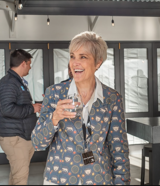A GoReefers team member laughing with colleagues at a company gathering.
